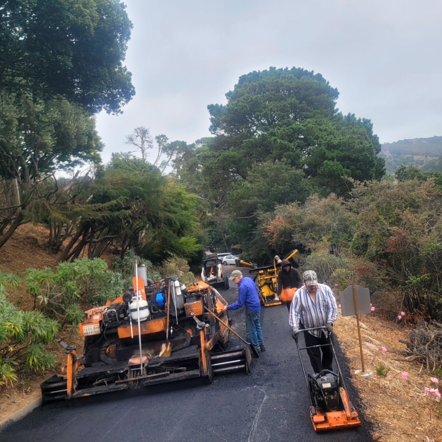 Thornton Paving crew installing an asphalt overlay on a hillside road