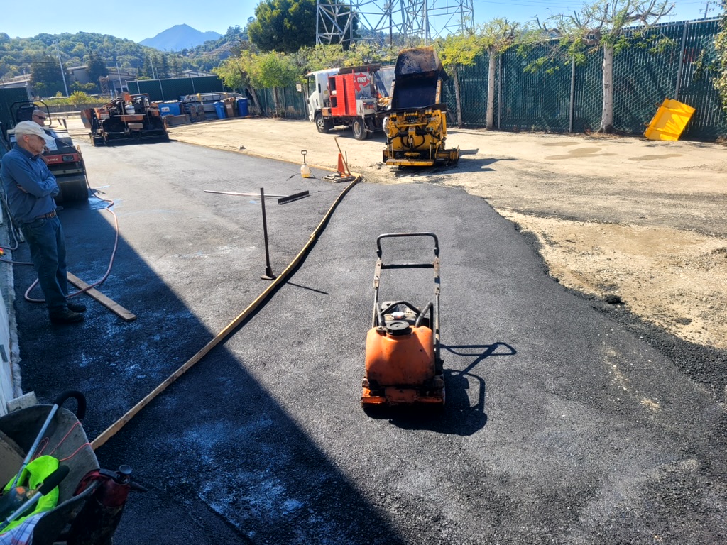 Thornton Paving equipment working in an irregular asphalt area