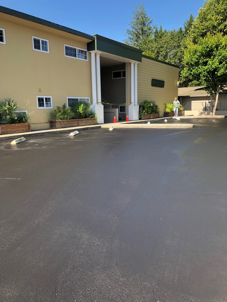 Commercial parking lot after seal coating and striping work